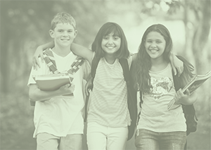 Three junior high students walk together holding books