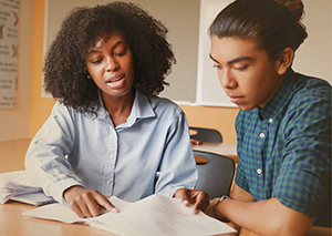 Teacher working with young man