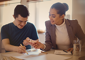 Teacher working with student who is writing