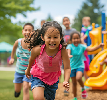 Young girl leader a group of children running in playground