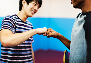 Two young men fist bump