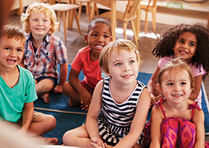 Preschoolers sitting attentively in school setting