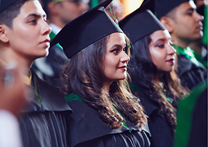 High school graduates standing proudly during ceremony