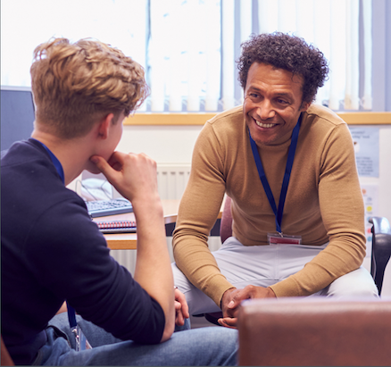 Student and counselor meet in an office